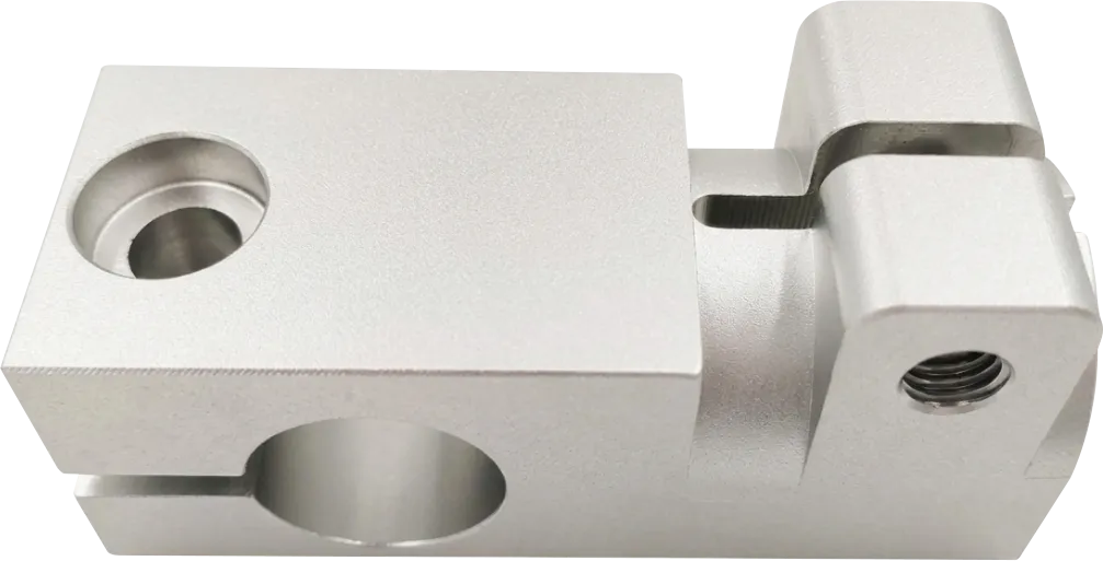 CNC machined aluminum mounting block with a counterbored slot.