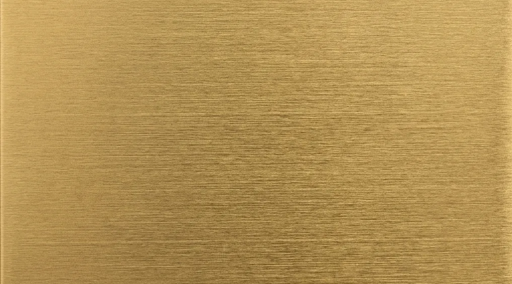 Brushed brass sheet metal surface swatch.
