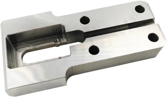 CNC machined carbon steel block with a milled pocket.