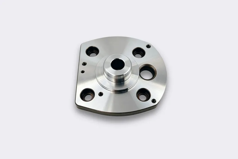 CNC machined carbon and alloy steel flange plate with a bolt pattern.
