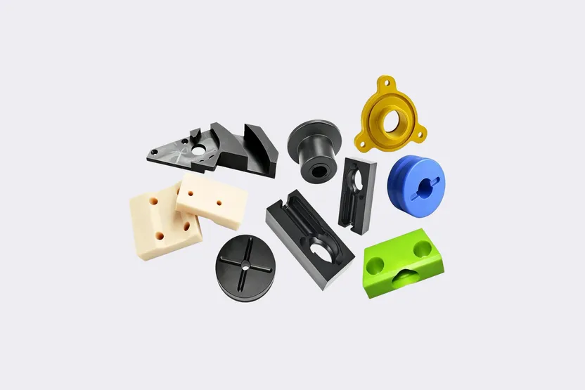 CNC machined engineering plastic components in assorted colors and geometries.