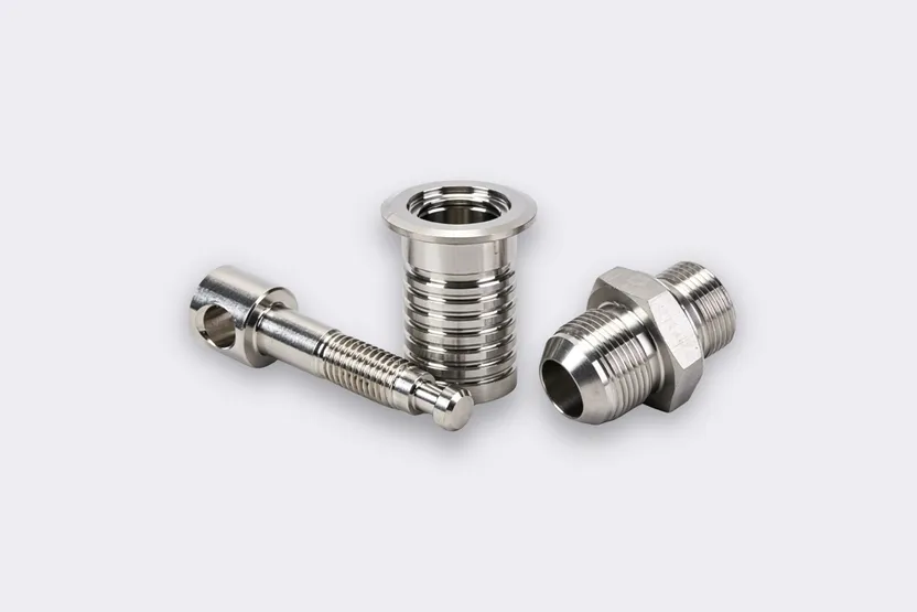 CNC machined stainless steel fasteners and threaded fittings.