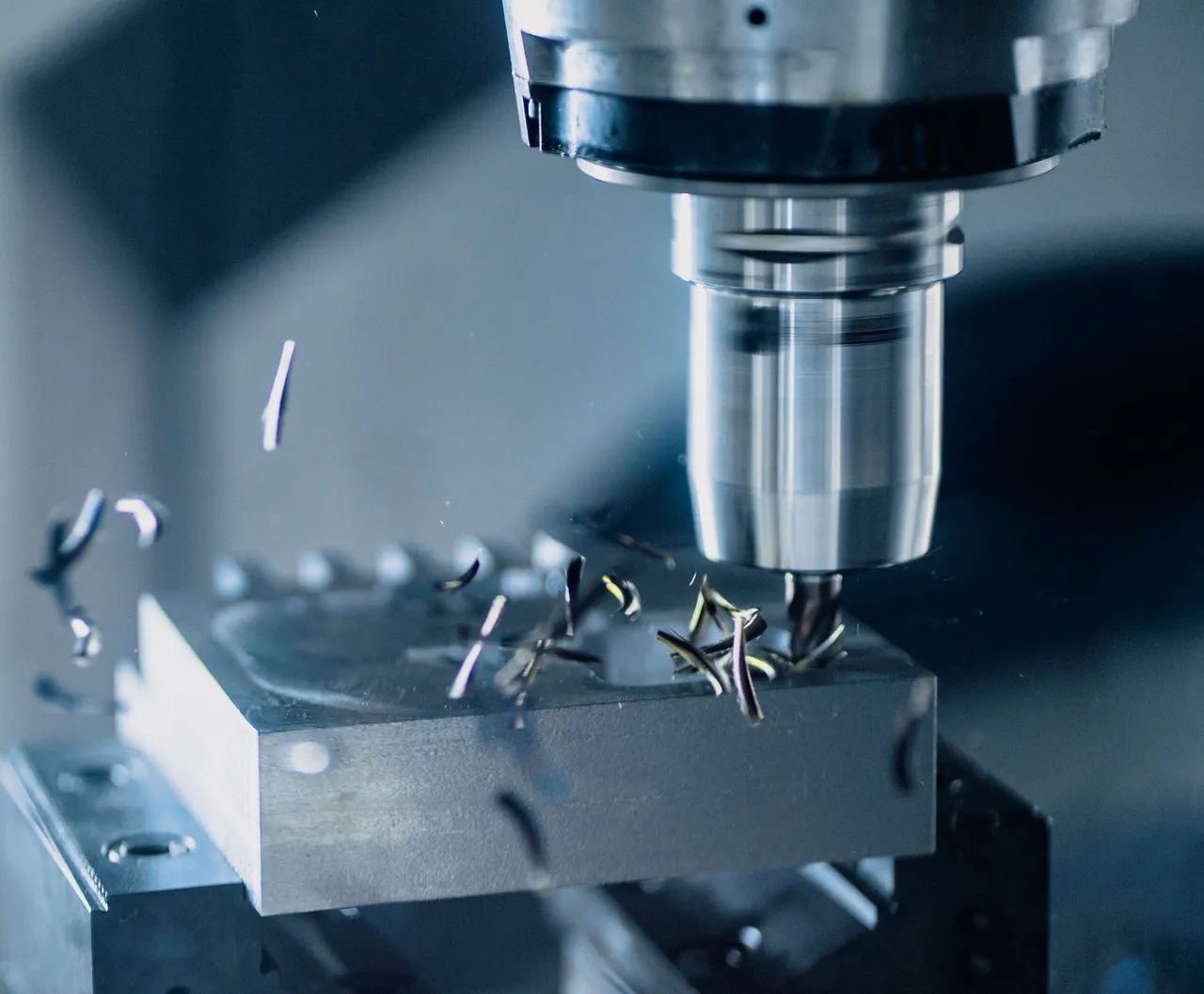 CNC milling cutter machining a metal part on a vertical machining centre.