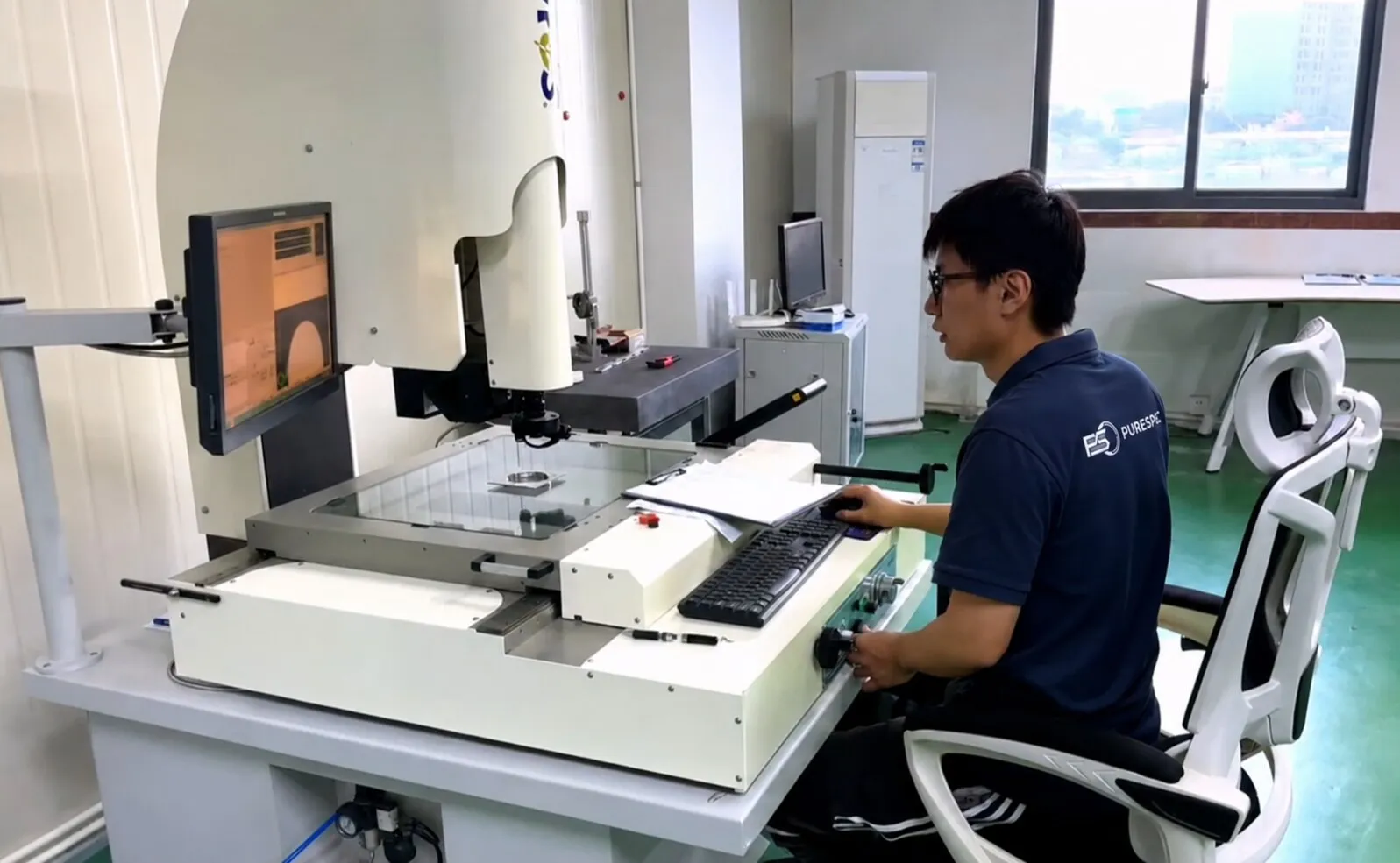 Inspector measuring a first article sample on a 2.5D vision measurement system.