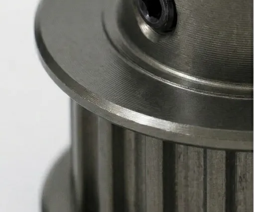 Close-up of a hardcoat anodized aluminum pulley showing the dark gray coating.
