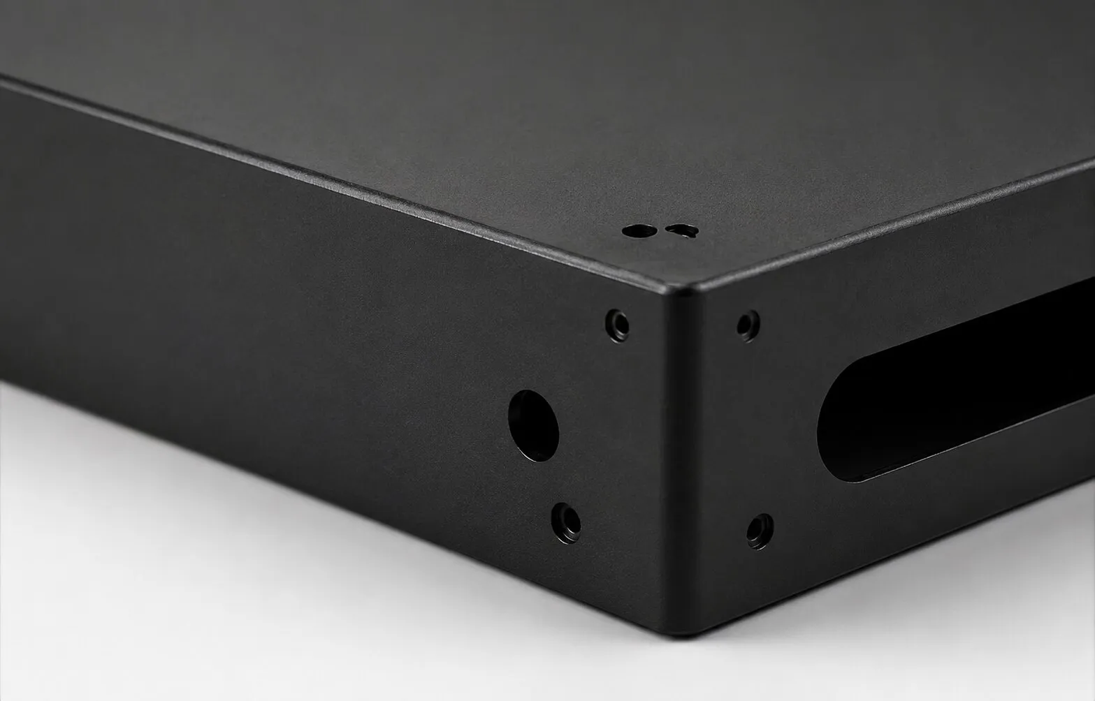 Matte textured powder coated sheet metal panel edge.