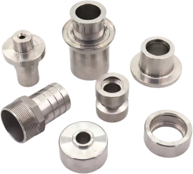 Group of passivated stainless steel machined fittings and bushings.