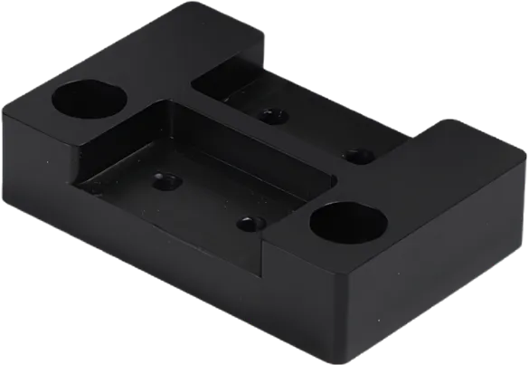 Machined POM block with counterbored holes.