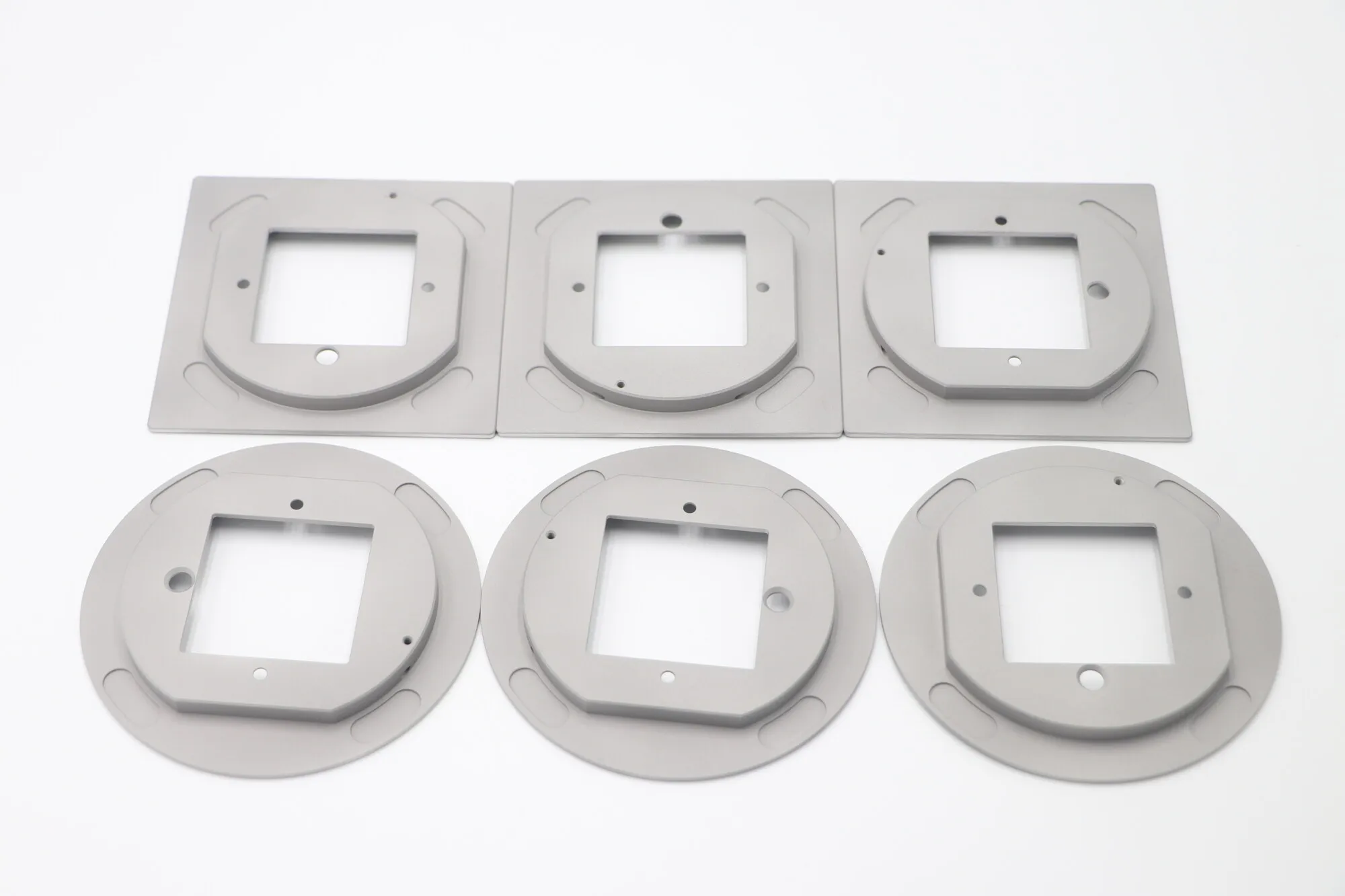 Machined aluminum and brass flange plates with square apertures and sealing faces