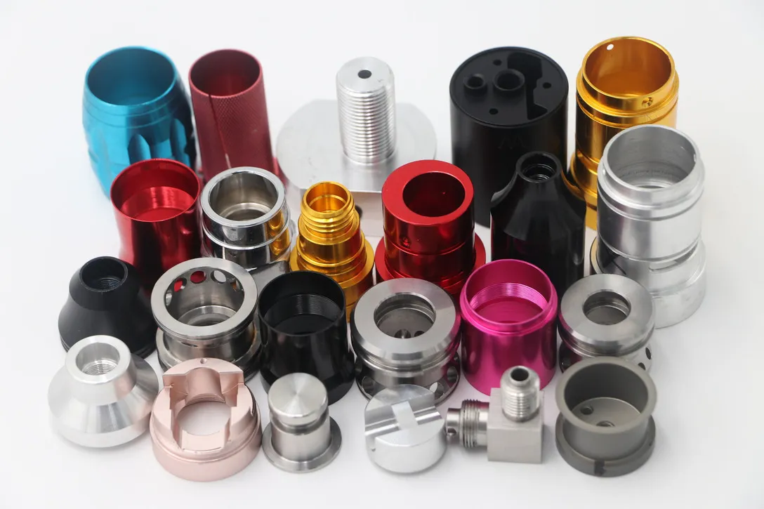 Group of CNC turned aluminum collars and caps anodized in red, gold, pink, black and silver