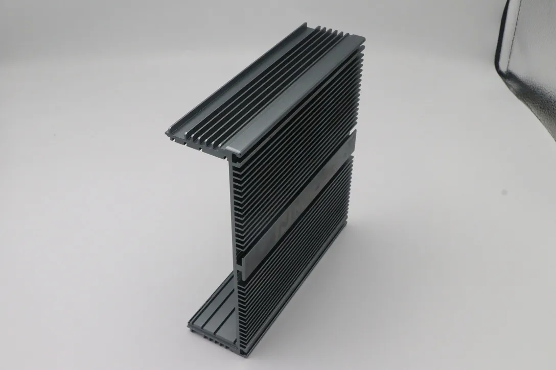 Black anodized finned aluminum extrusion with machined ends and mounting slots