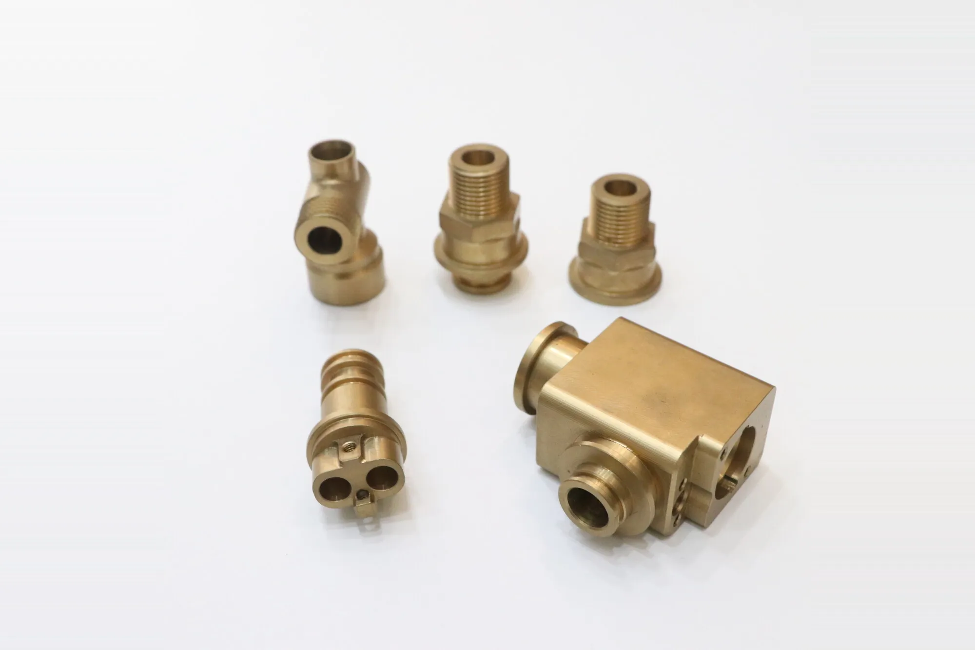 Set of machined brass fittings and valve bodies with threaded ports