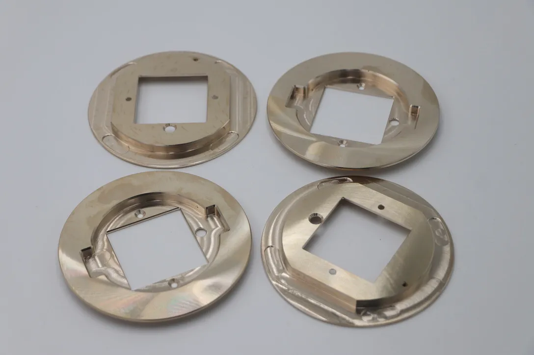 Set of machined brass flange rings with square apertures and countersunk holes