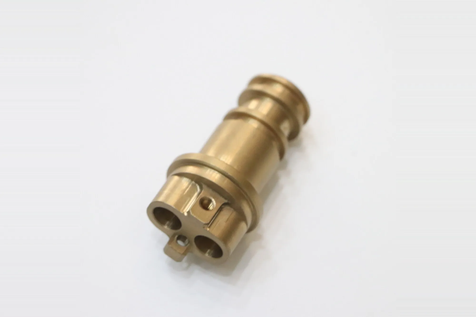 Machined brass manifold fitting with multiple drilled ports and turned sealing faces