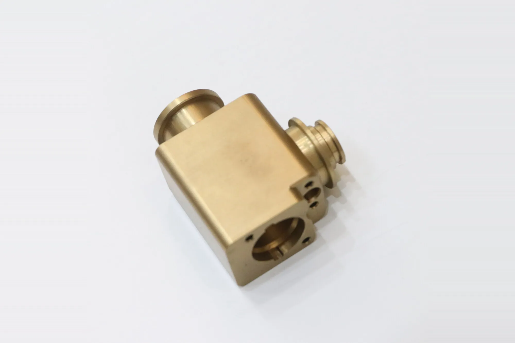 Machined brass valve body with square section, ported faces and turned sealing bosses