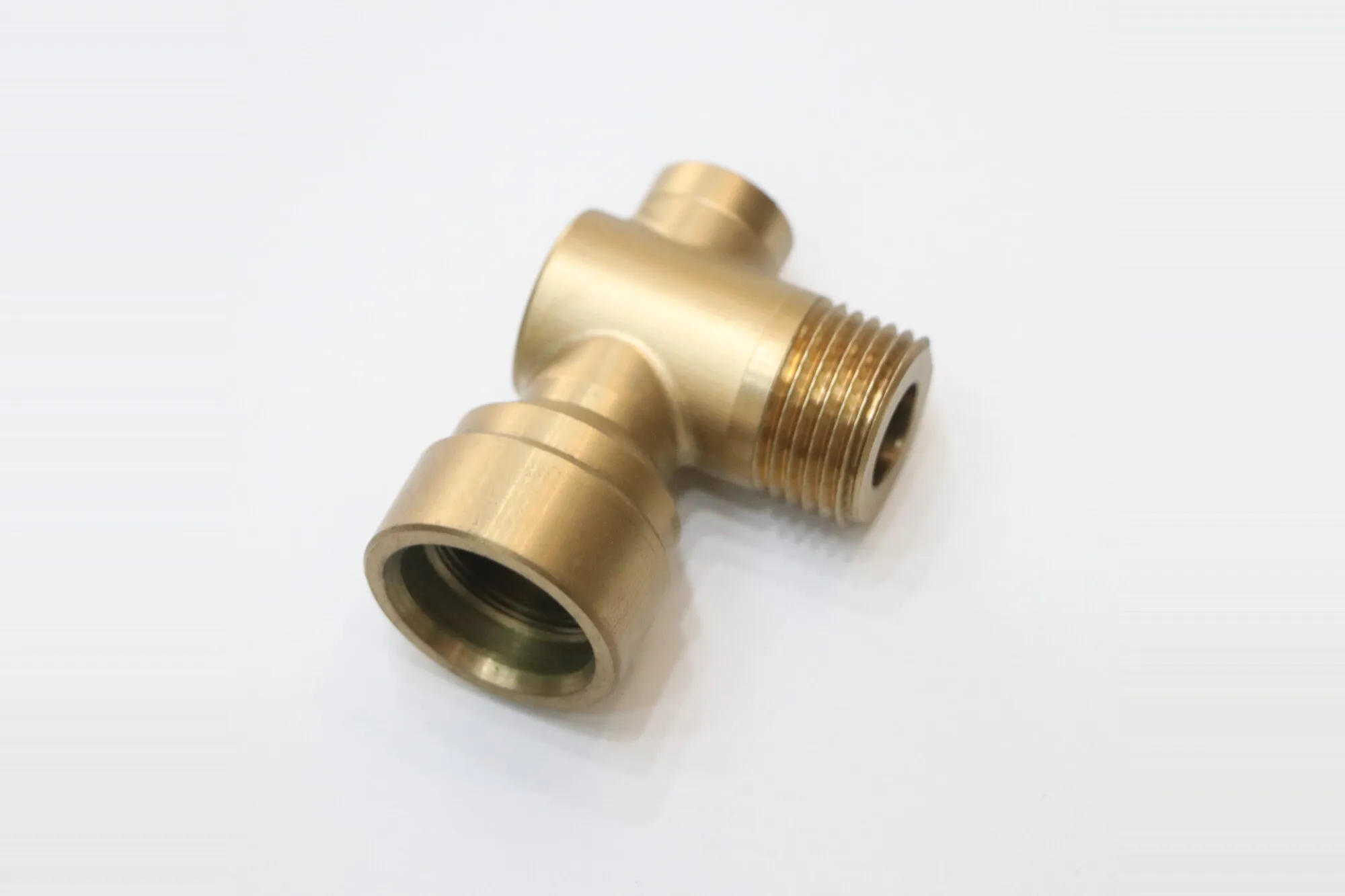 Machined brass valve body with threaded outlet and cross-drilled internal ports