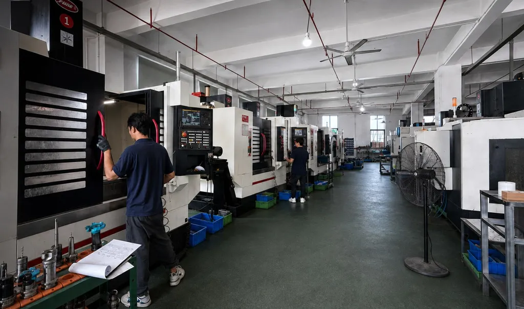 A row of CNC machining centres running on the PURESPEC shop floor.