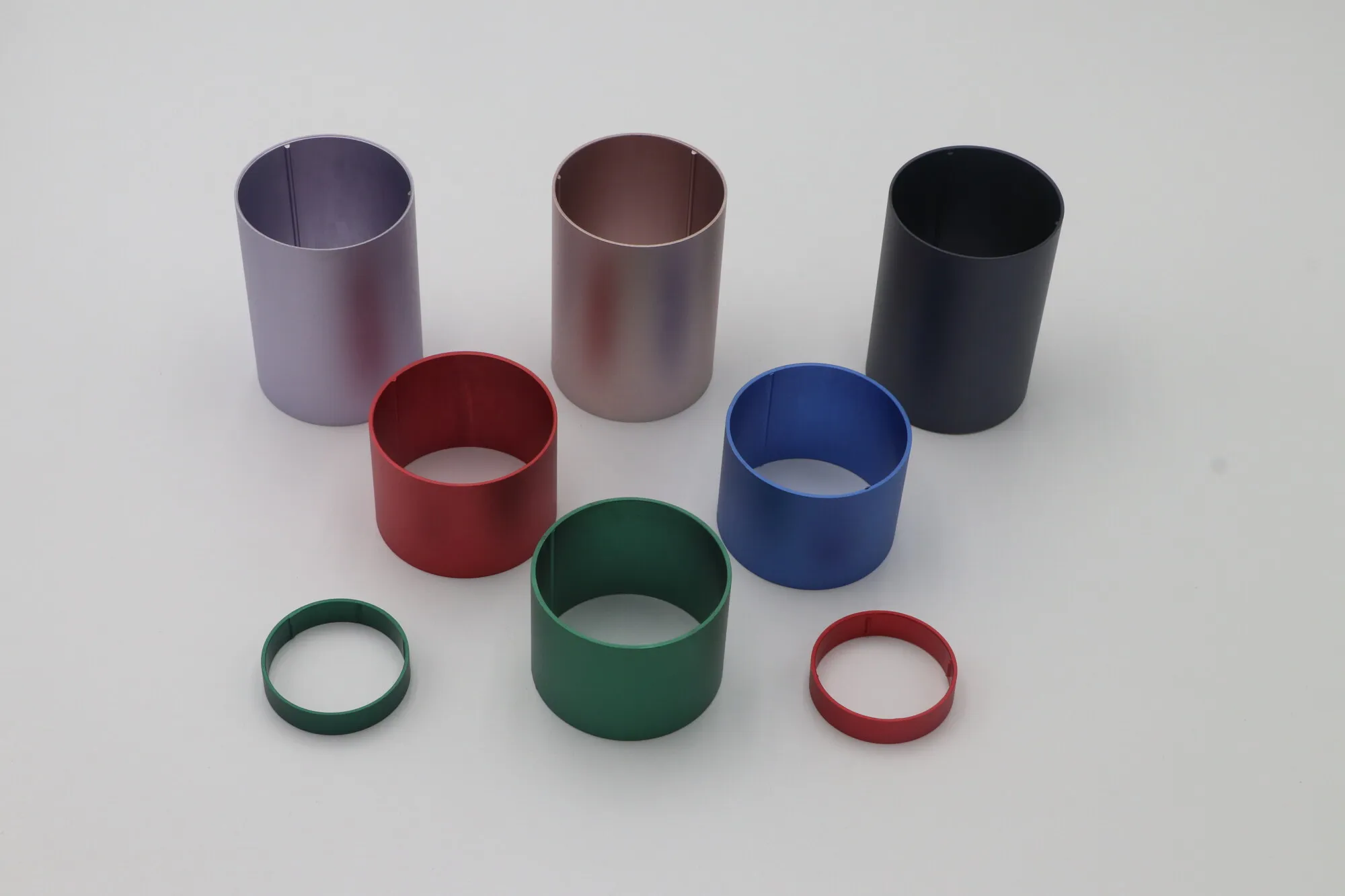 CNC turned aluminum rings and sleeves anodized in green, red, blue, purple and bronze