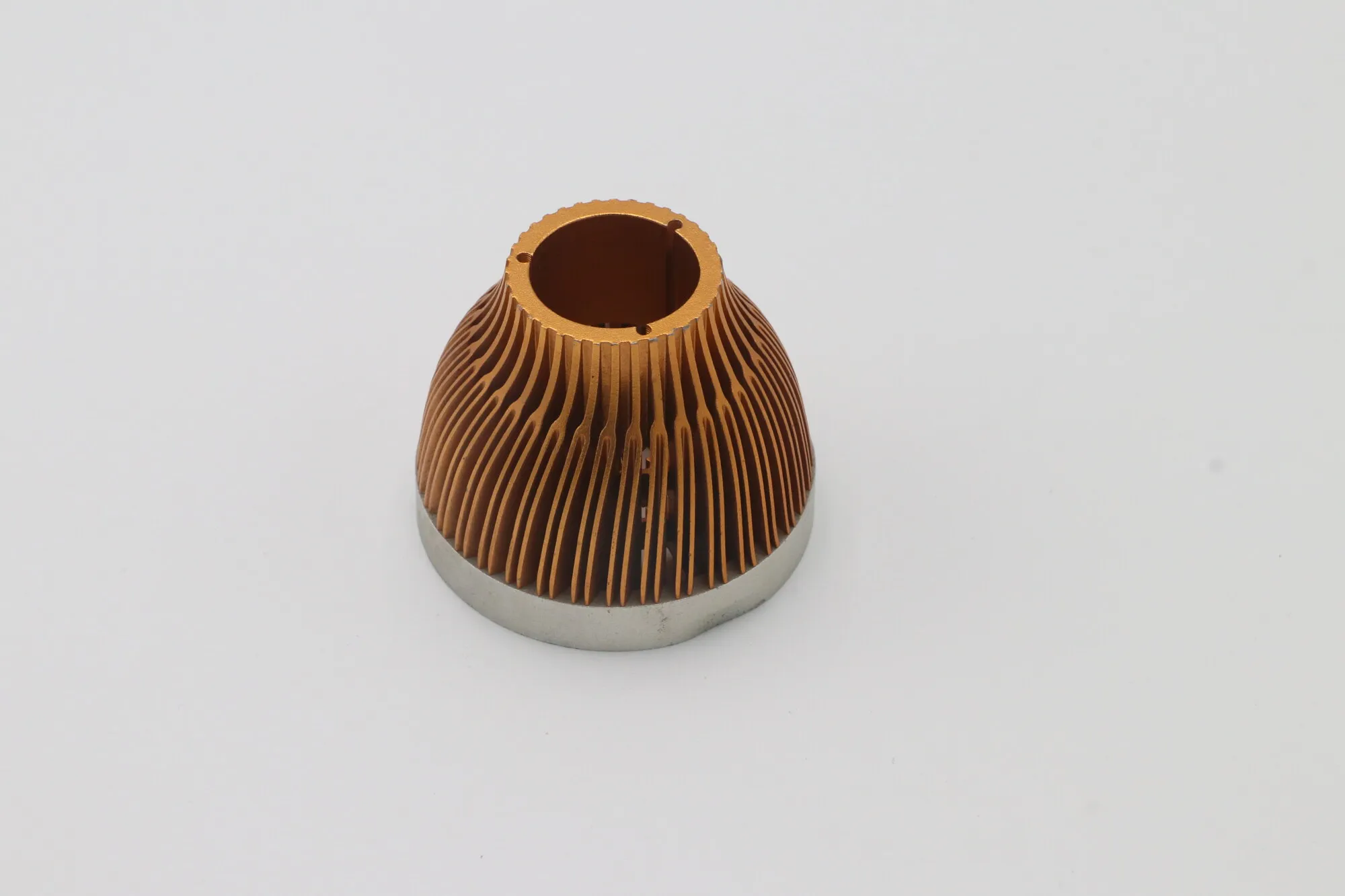 Copper-colored anodized aluminum lamp heat sink with radial fins and an internal driver bore