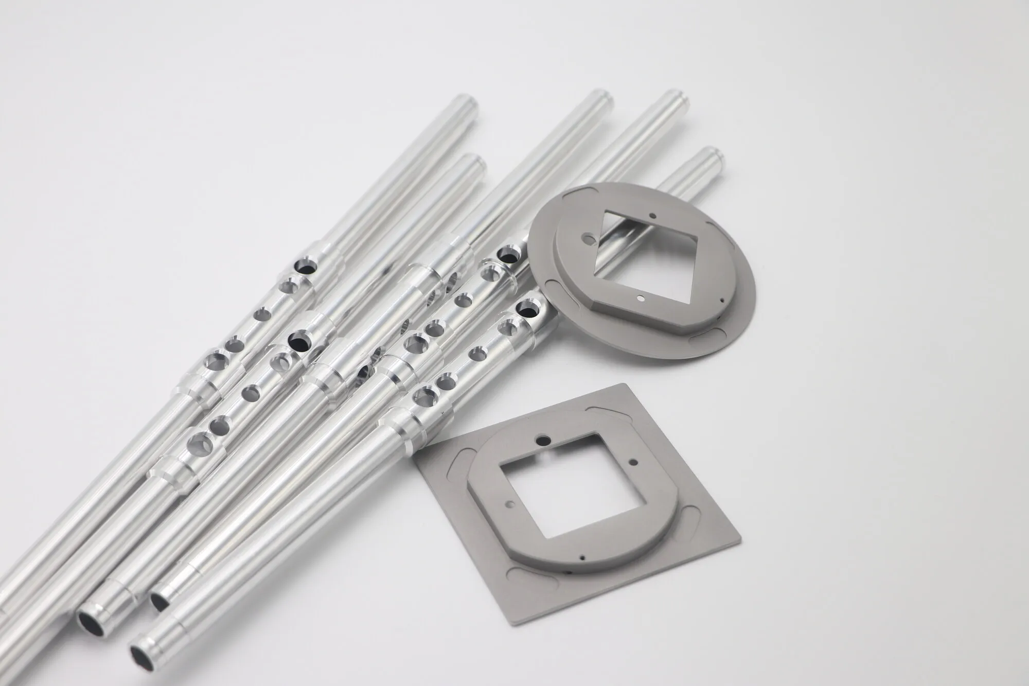 Slender CNC machined aluminum tubes with counterbored holes and swaged steps
