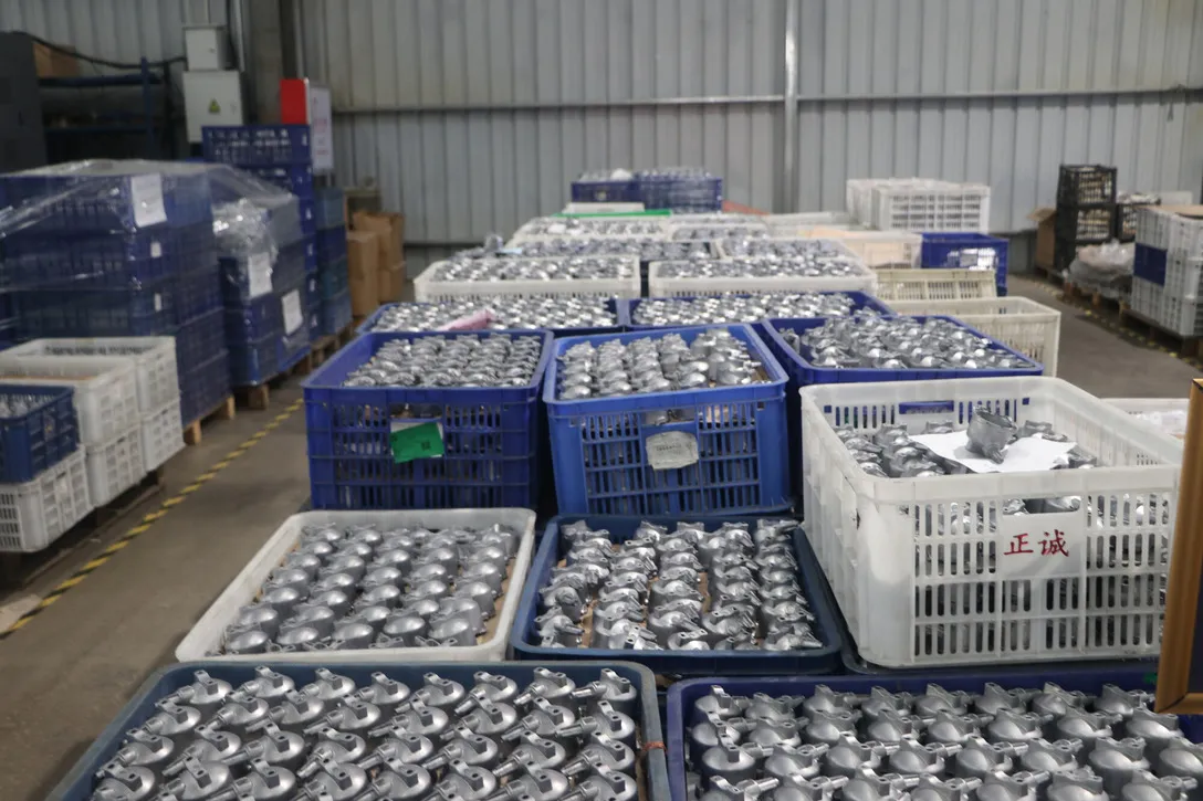 Crates of finished machined aluminum parts staged for inspection