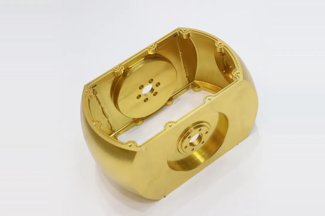 Machined aluminum housing with gold plated cosmetic finish and internal bearing seats
