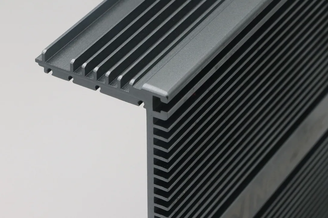 Close detail of closely spaced fins on a black anodized aluminum heat sink extrusion