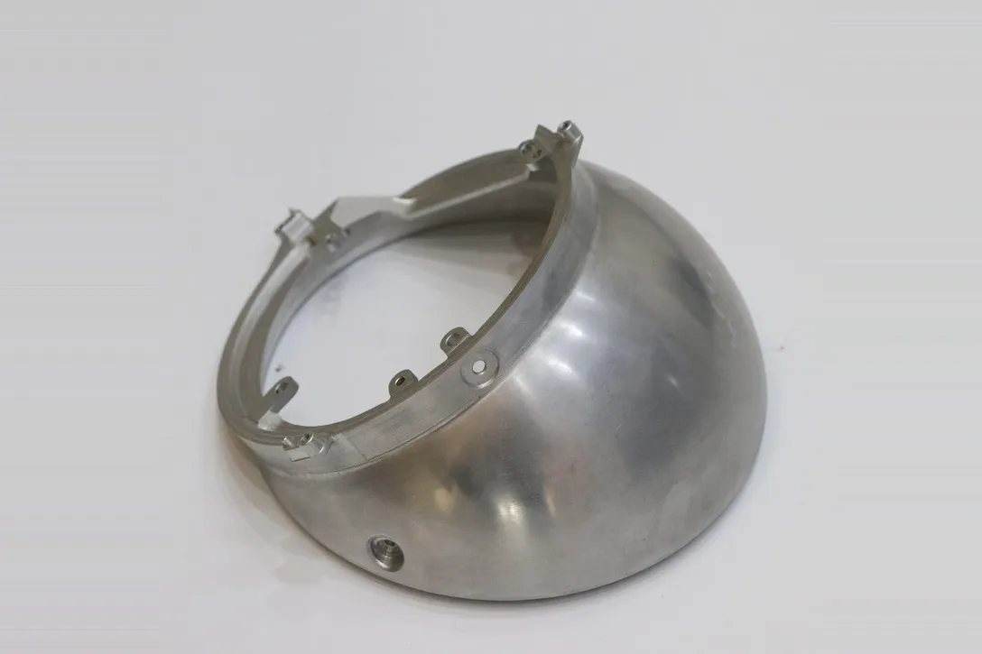 Machined aluminum dome housing with spun profile, machined edge features and mounting tabs