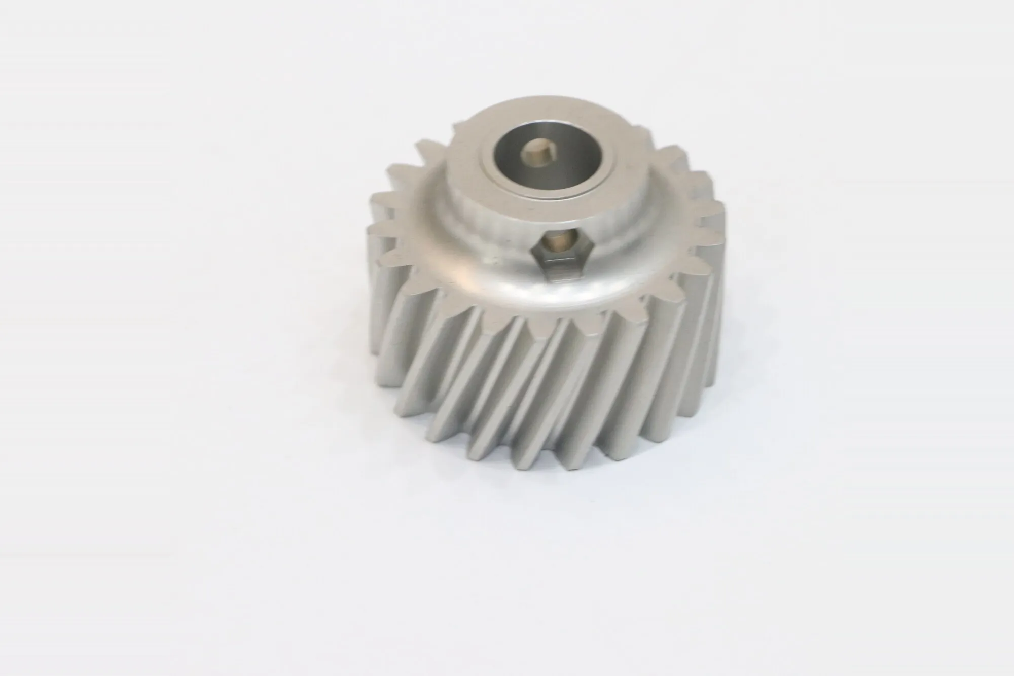CNC machined pinion gear with helical cut teeth and bored hub