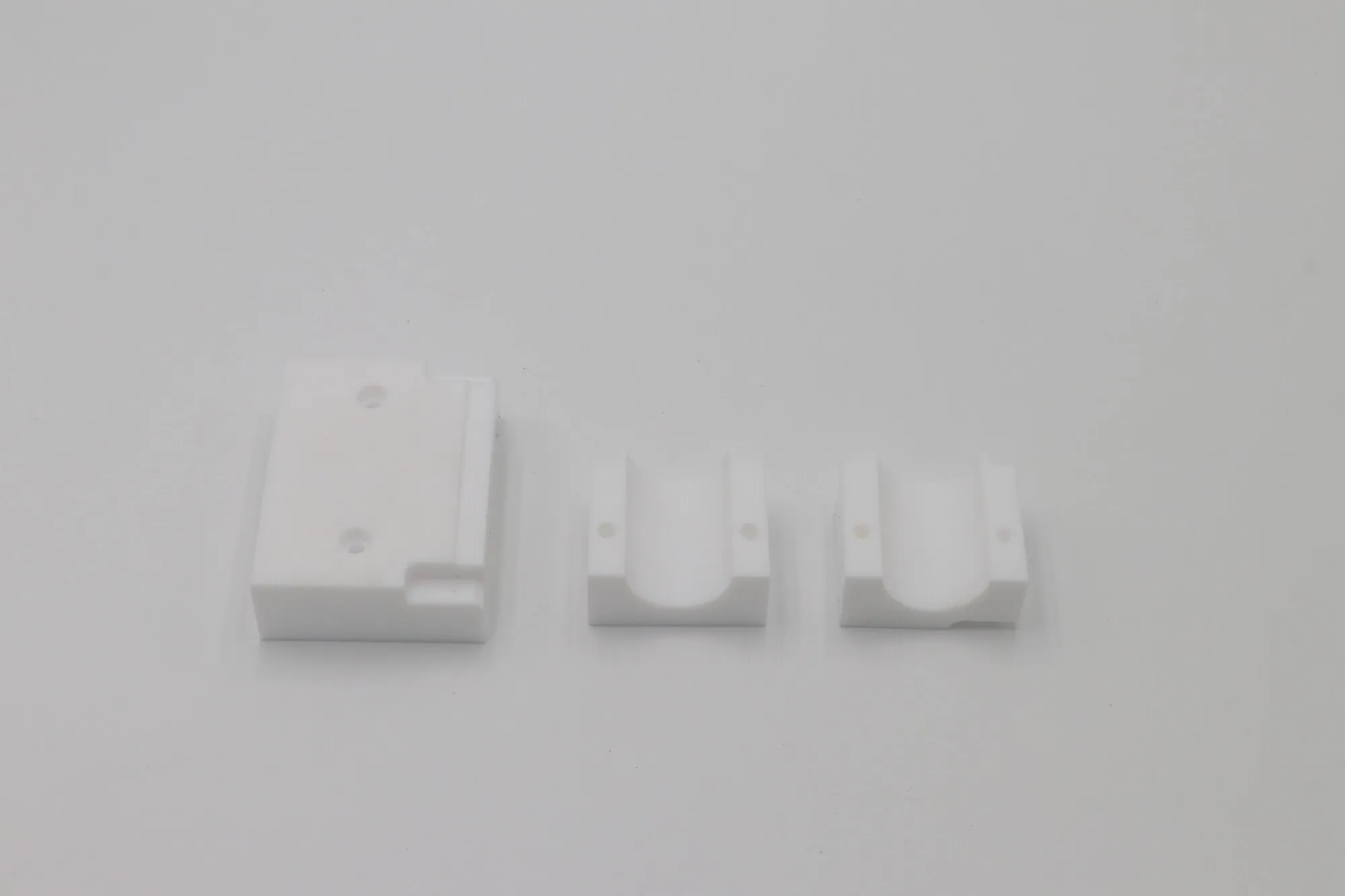 Machined white POM plastic blocks and bearing carriers