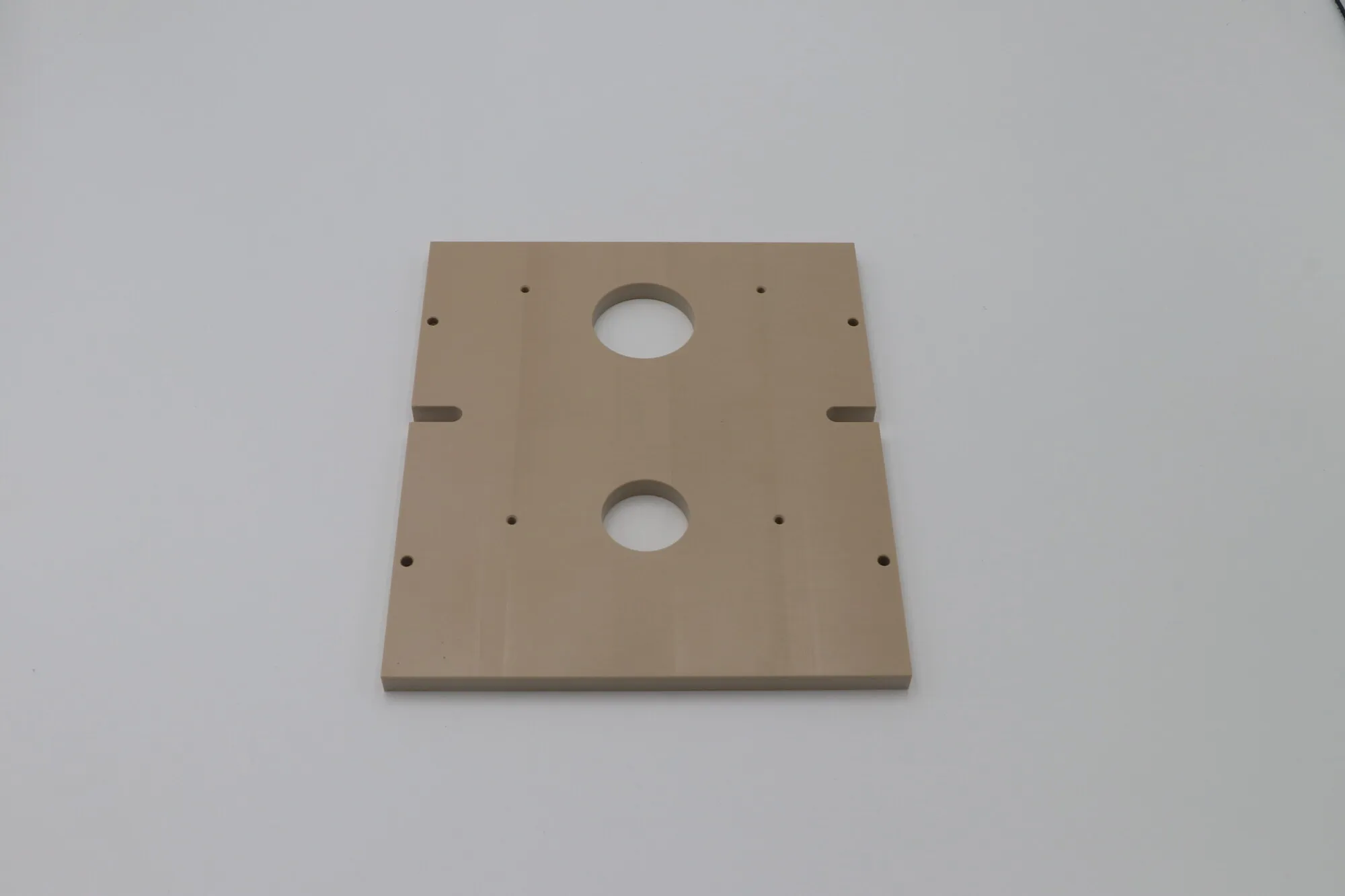 Machined PEEK plate with bored apertures and milled slots
