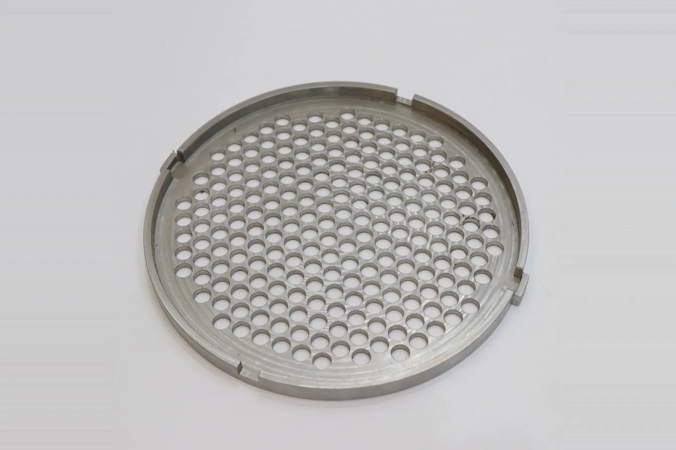 Machined aluminum perforated plate with a dense pattern of drilled holes
