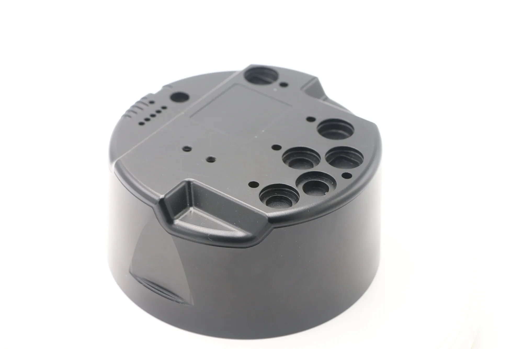 Round machined aluminum instrument housing with counterbored ports and a black anodized finish