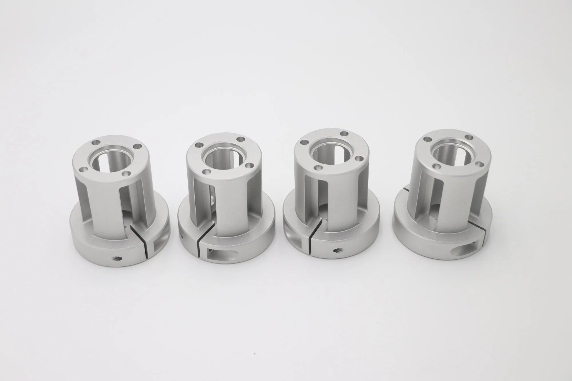 Set of split clamp bushings machined in aluminum with slotted flanges