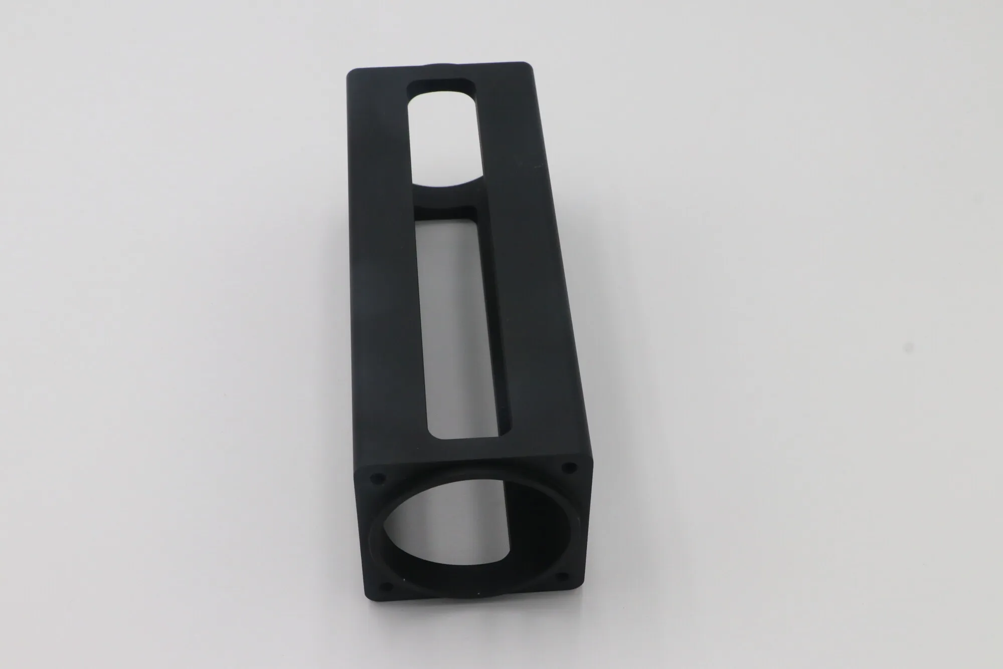 Square tube machined aluminum housing with milled windows and black anodized finish