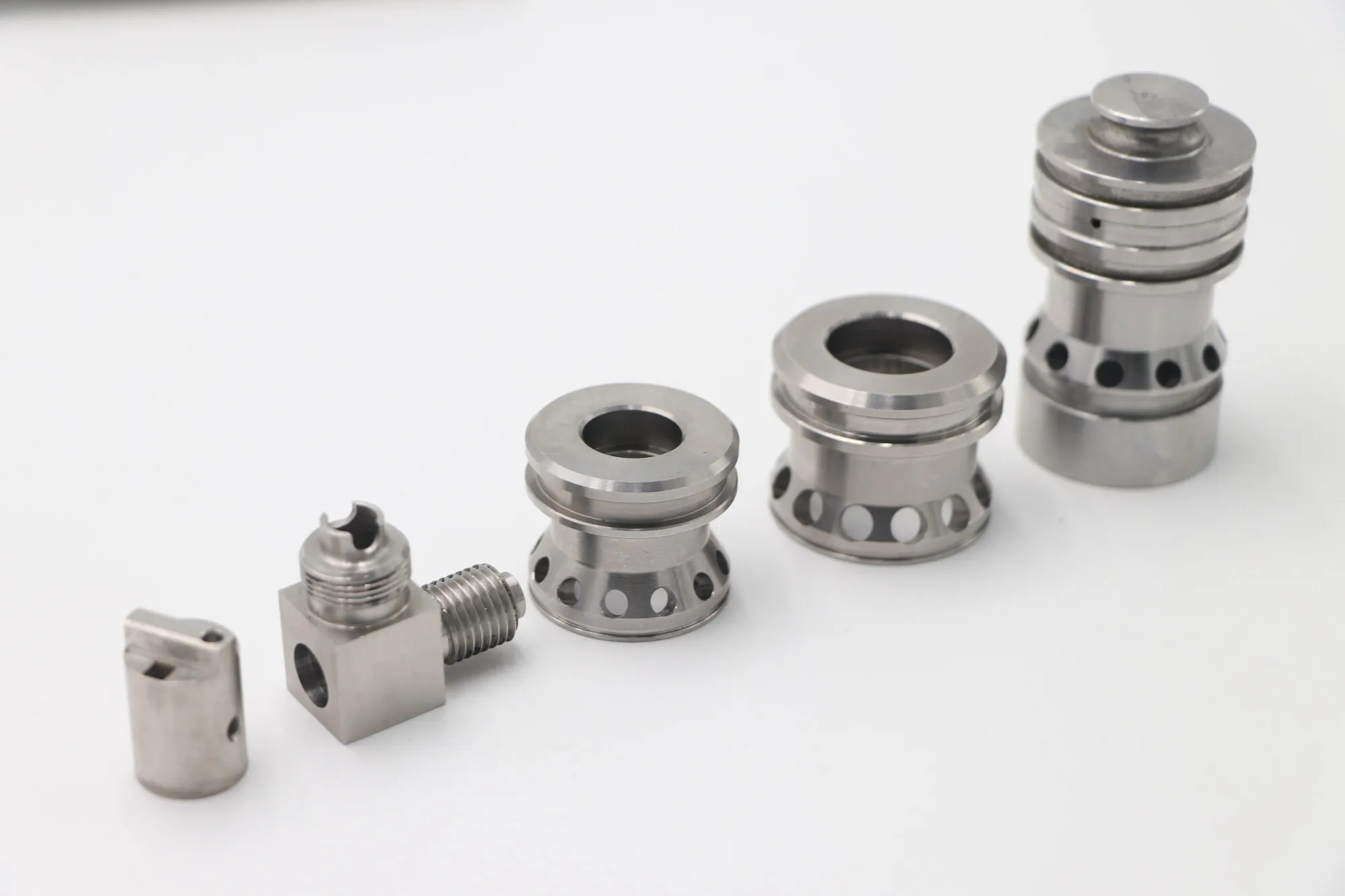 Set of CNC turned stainless steel valve spools with cross-drilled ports