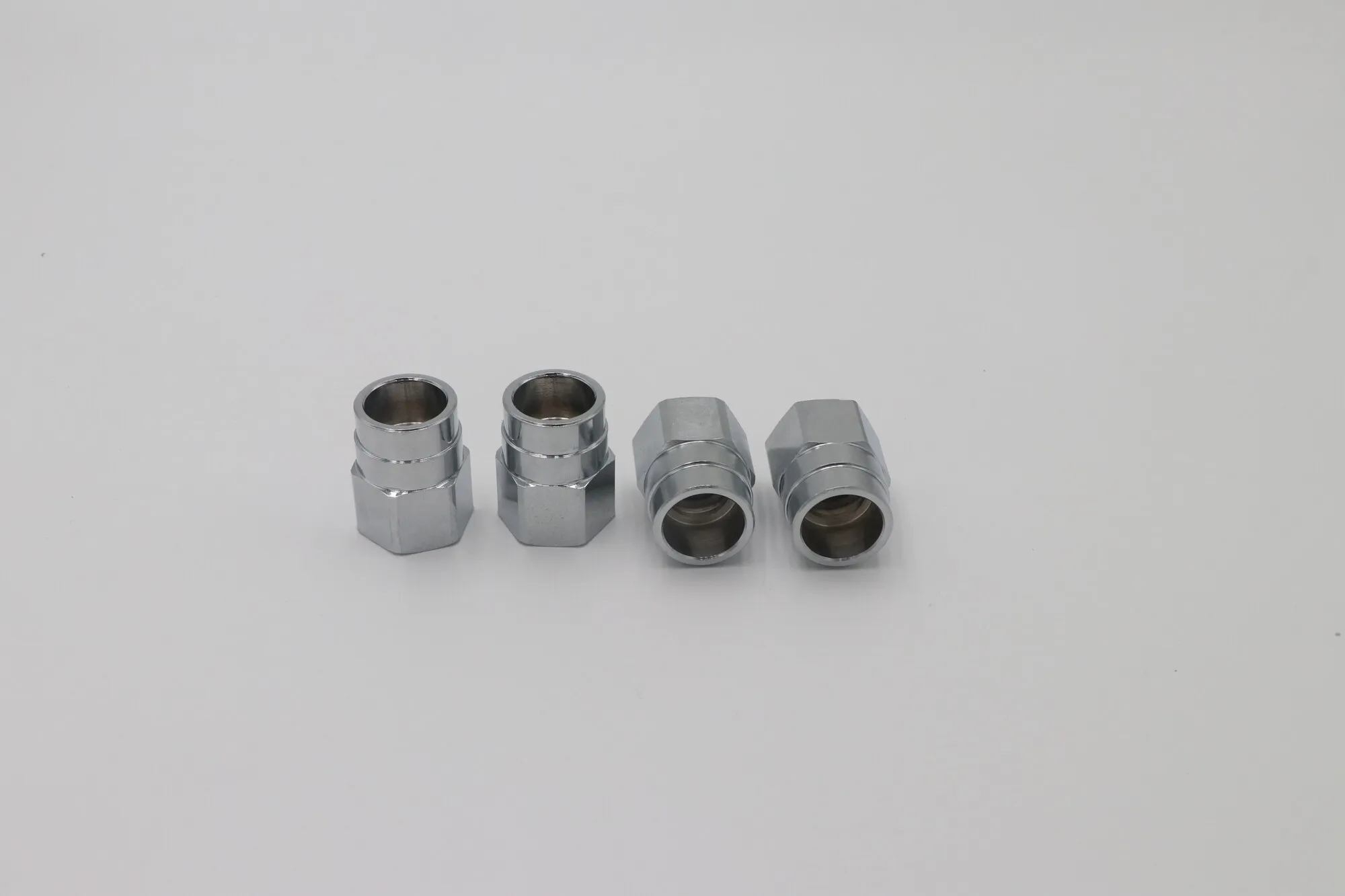 Set of CNC turned aluminum hex bushings with plated finish