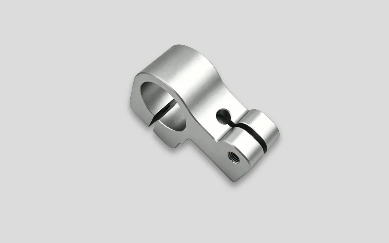 A white anodized aluminum CNC-machined clamp.