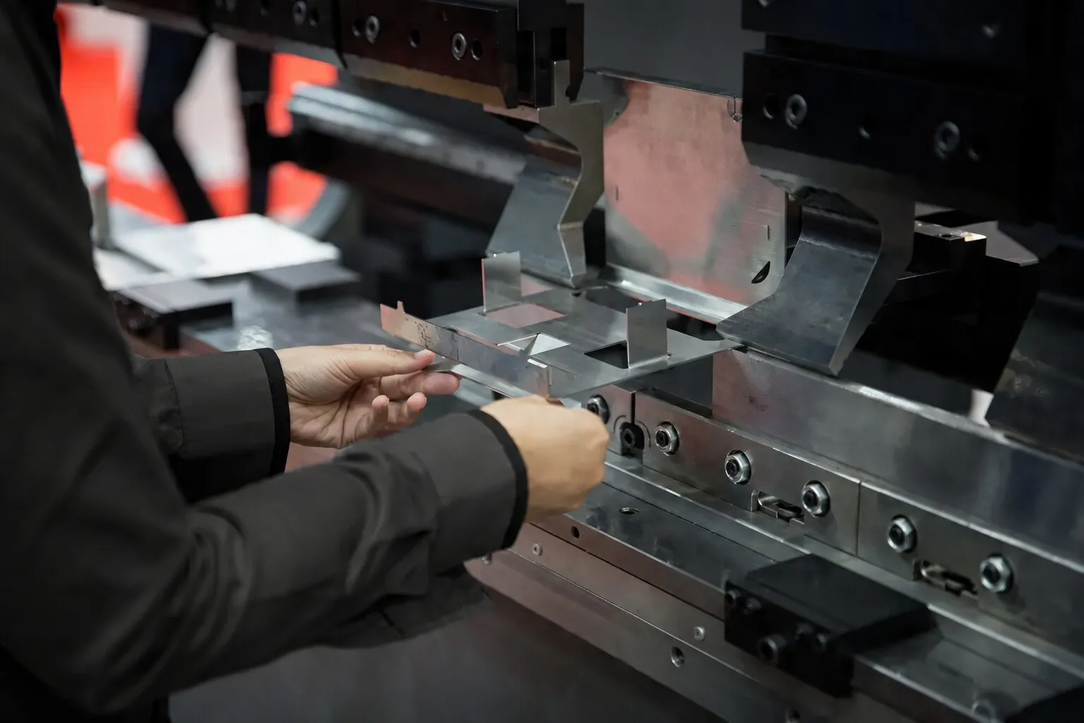 Operator forming a sheet metal part on a press brake.