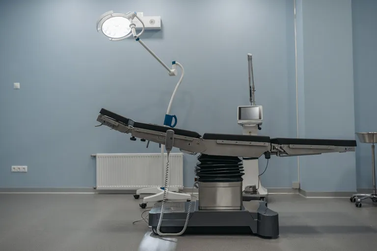 Precision technical equipment assembly in a clinical setting.