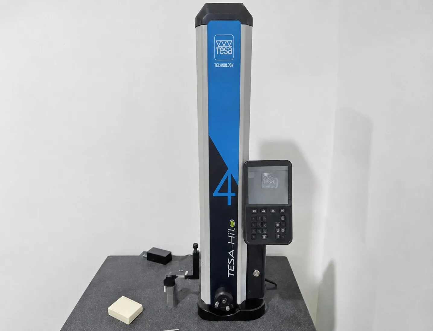 TESA-Hite digital height gauge standing on a granite surface plate.