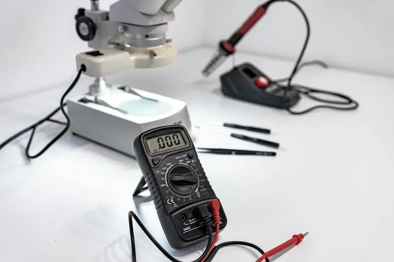 Bench multimeter and probes used for electrical testing and measurement.